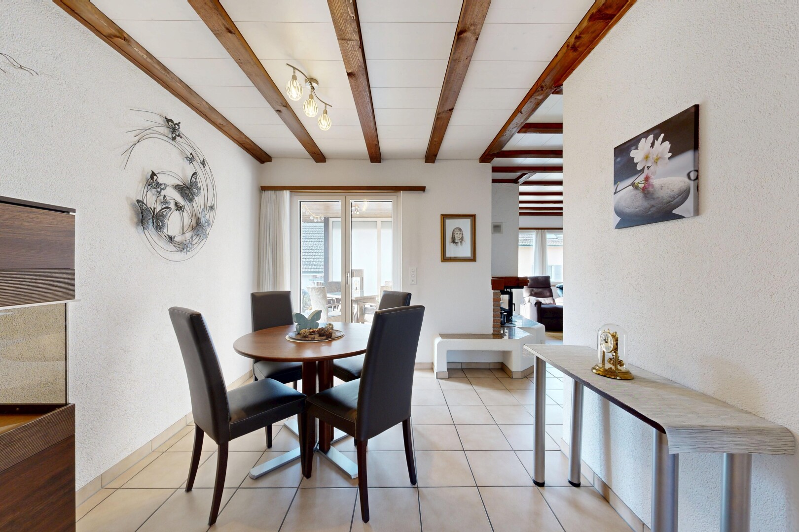 dining area with beamed ceiling and light tile patterned floors