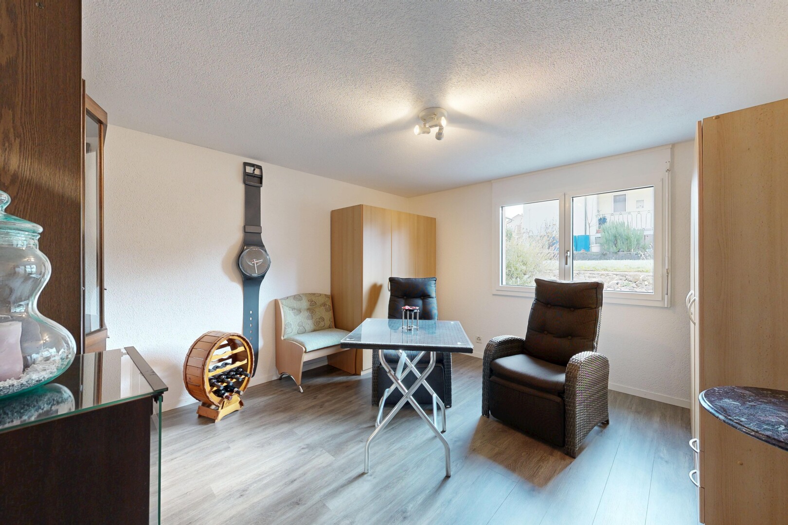 living room with a textured ceiling and wood finished floors