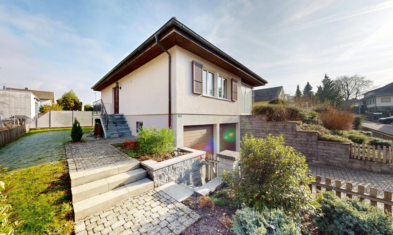 view of property featuring stucco siding, an attached garage, and stairs