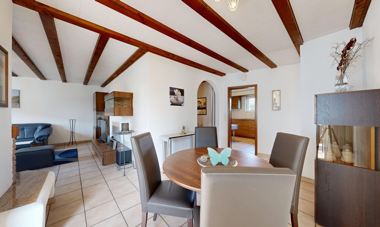 dining space with arched walkways, beam ceiling, and light tile patterned floors