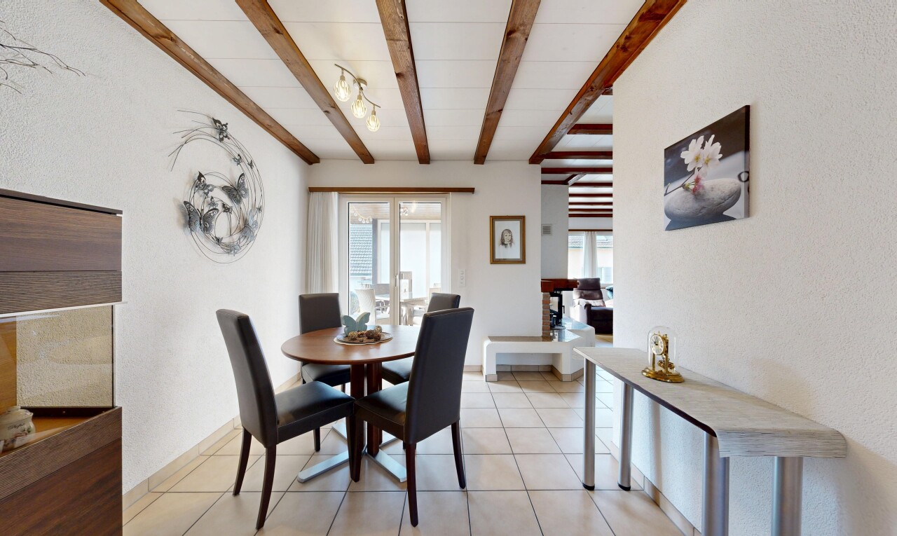 dining area with beamed ceiling and light tile patterned floors