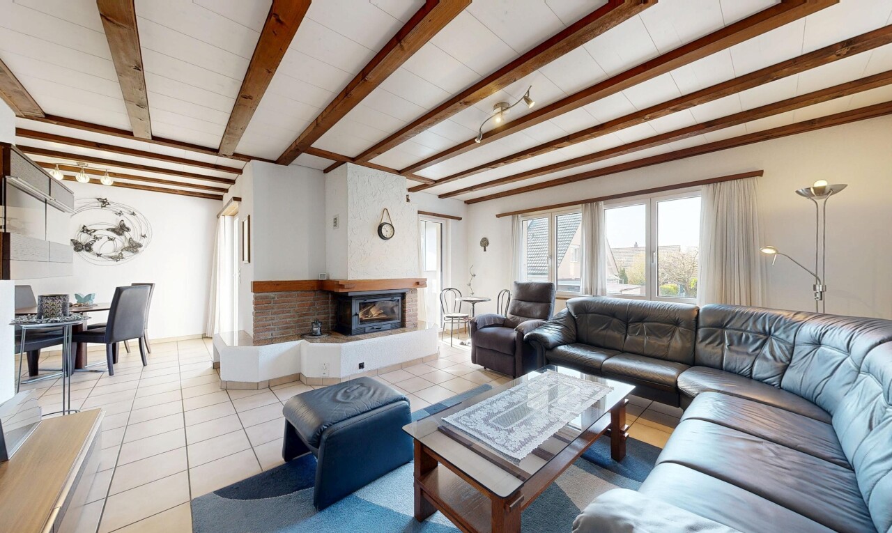 living / dining area featuring beam ceiling and tile patterned floors