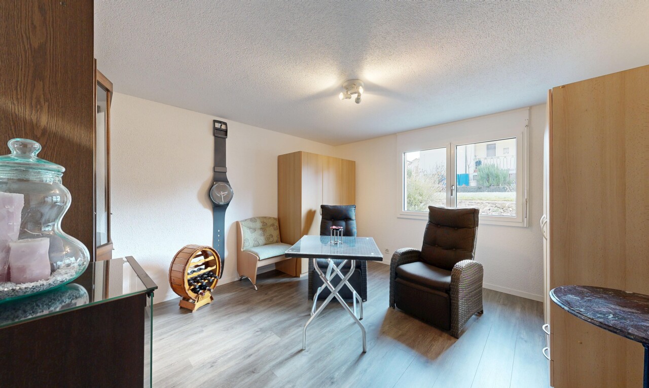 living room with a textured ceiling and wood finished floors