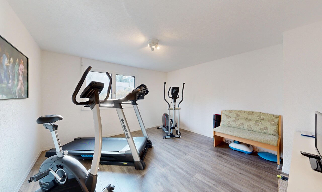 exercise room with wood finished floors
