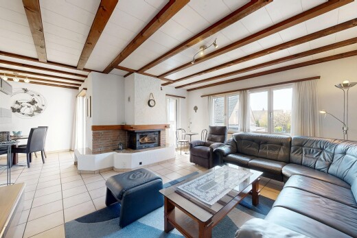 living / dining area featuring beam ceiling and tile patterned floors