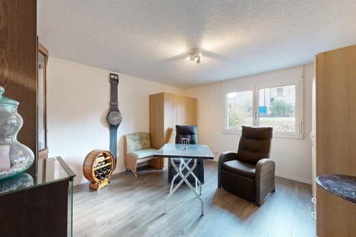 living room with a textured ceiling and wood finished floors