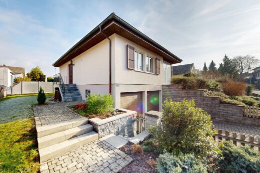 view of property featuring stucco siding, an attached garage, and stairs