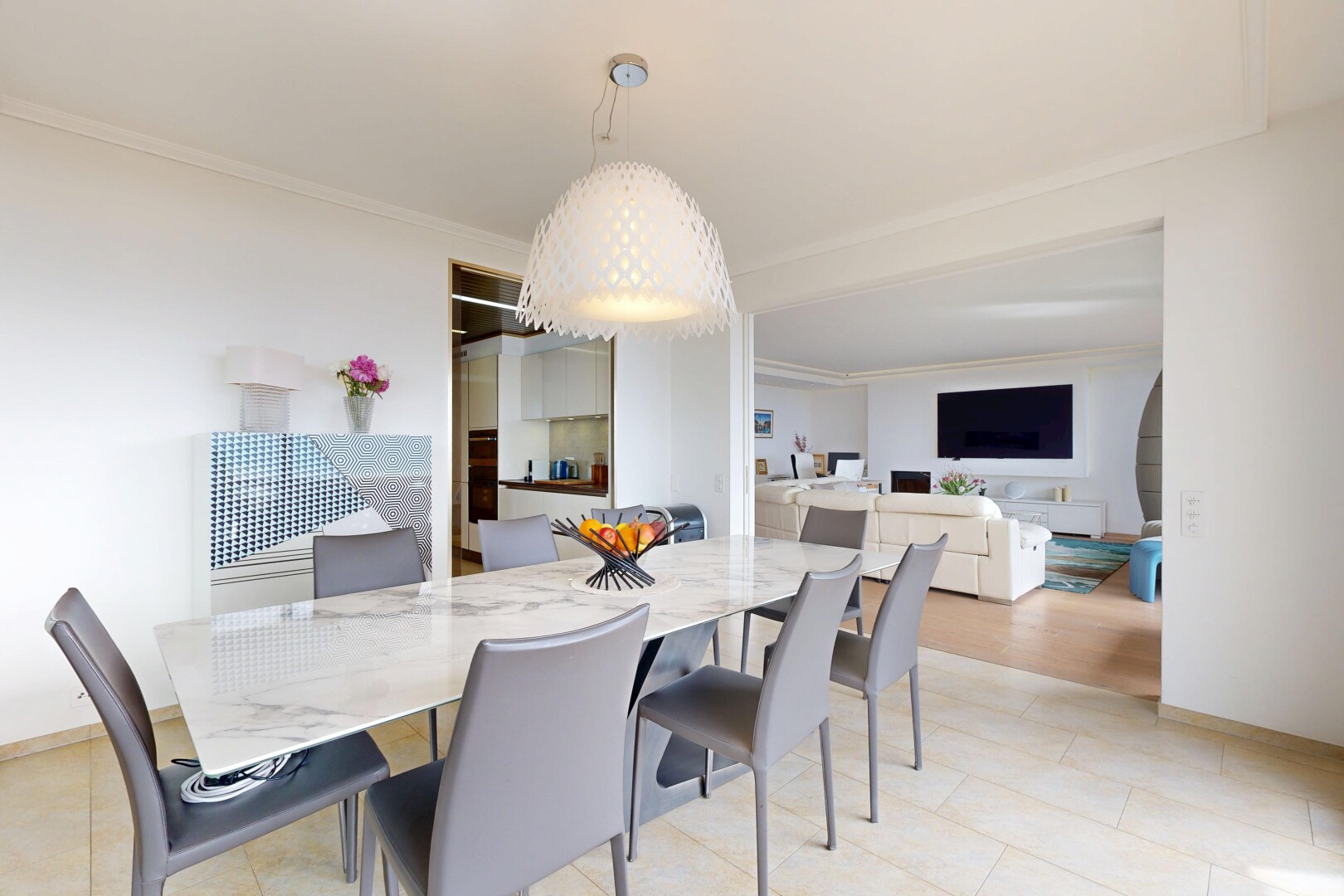 living / dining room with ornamental molding and light tile patterned flooring