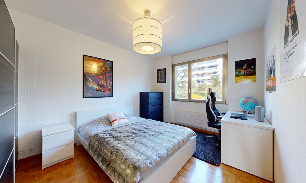 room / bedroom with parquet flooring and a desk