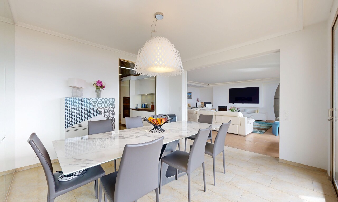 living / dining room with ornamental molding and light tile patterned flooring
