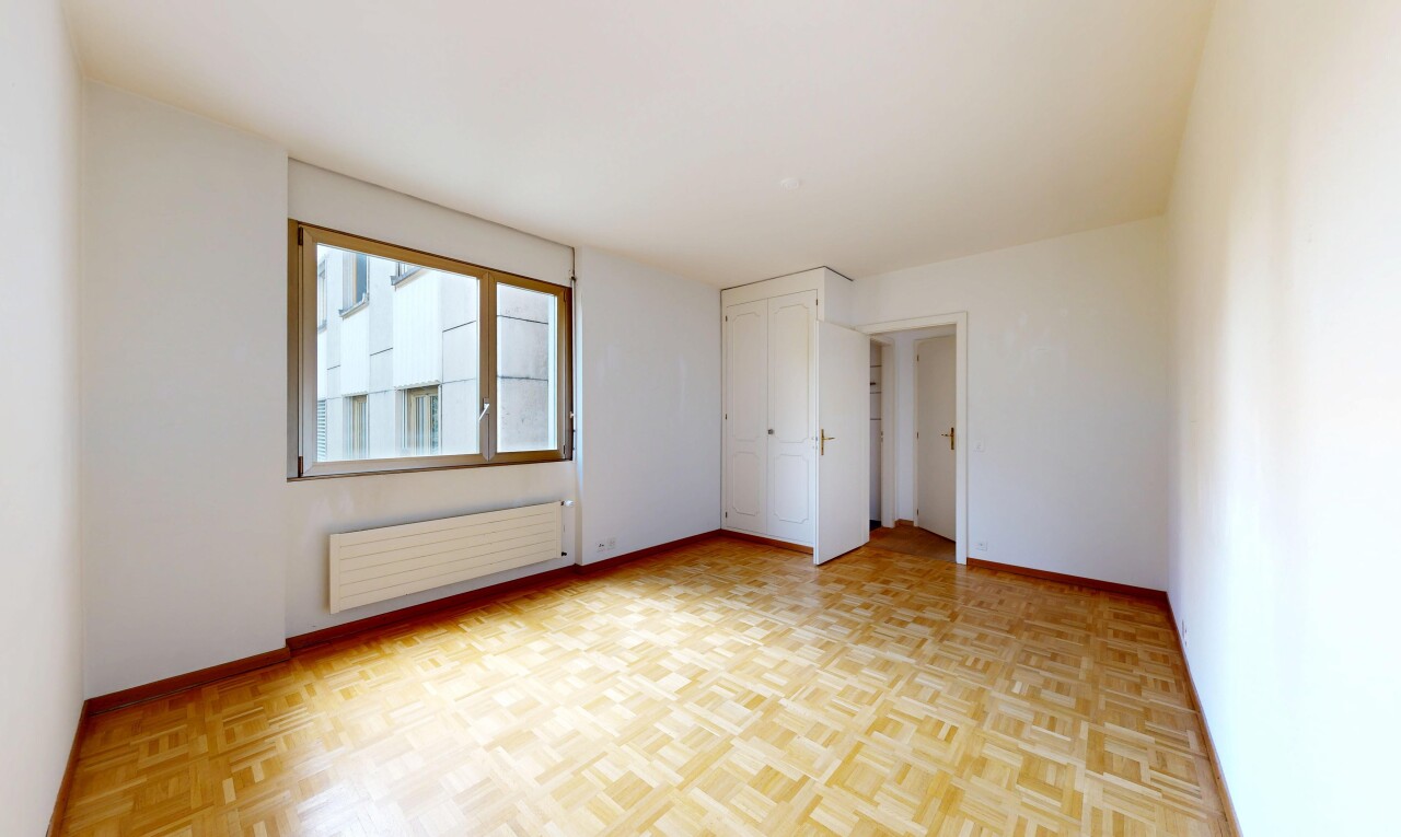 empty room featuring radiator and parquet floors