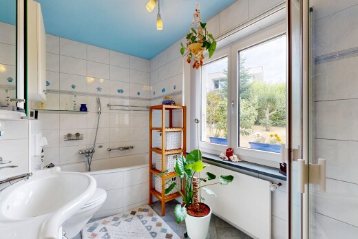 bathroom featuring tile walls, a relaxing tiled tub, a tile shower, and radiator heating unit