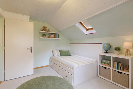 room / bedroom with vaulted ceiling with skylight, built in shelves, and light colored carpet