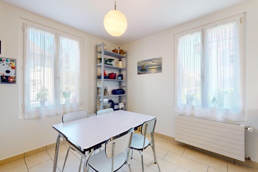 dining space featuring radiator heating unit, healthy amount of natural light, and light tile patterned floors