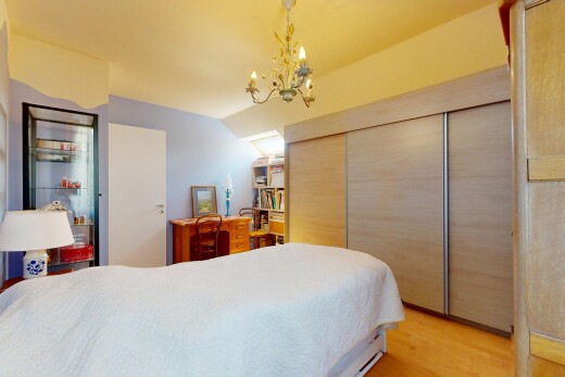 room with a chandelier, light wood-style floors, a closet, and lofted ceiling