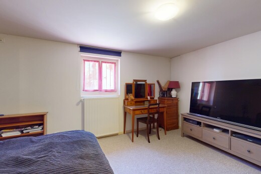carpeted room featuring radiator