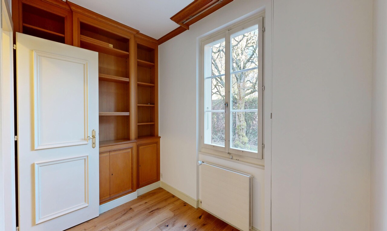 spare room with radiator heating unit and light wood-style flooring