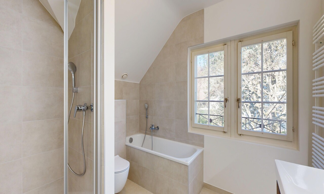 full bath with a garden tub, vanity, vaulted ceiling, tiled shower, and tile patterned flooring