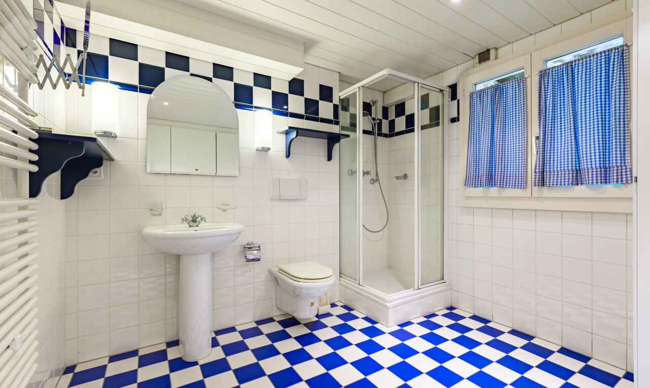 bathroom featuring tile walls, a shower stall, and tile patterned floors