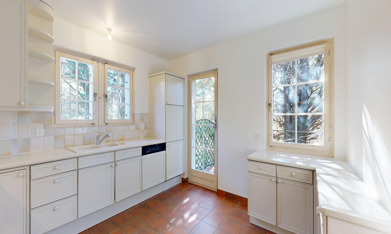 kitchen with light countertops, open shelves, healthy amount of natural light, and white cabinets