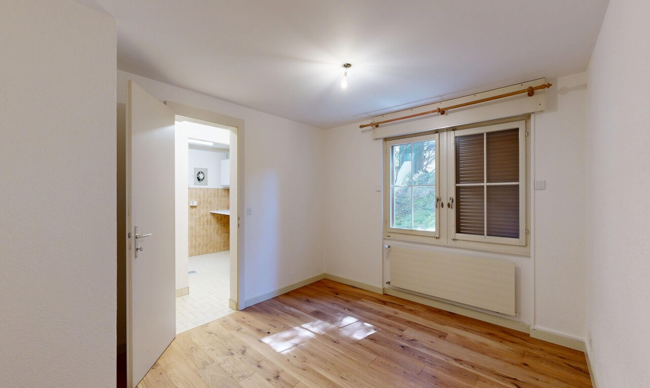 empty room featuring radiator heating unit and light wood-style floors