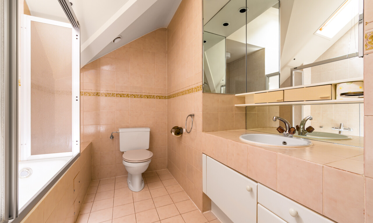 bathroom featuring tile walls, tile patterned floors, vanity, and washtub / shower combination