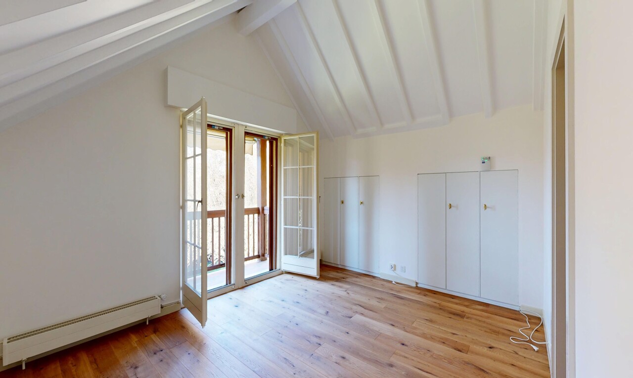 empty room with beamed ceiling, a baseboard heating unit, french doors, and light wood-style flooring