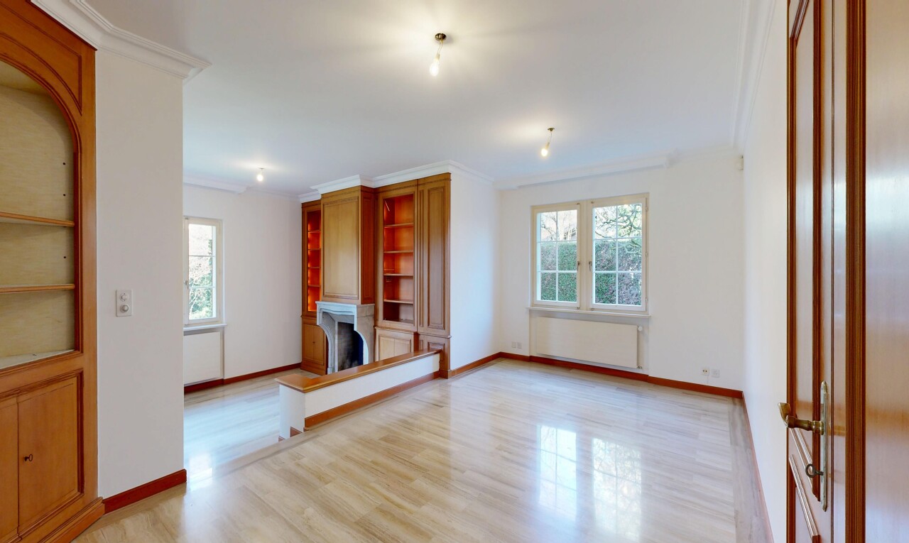 spare room with light wood finished floors, radiator heating unit, ornamental molding, and a fireplace