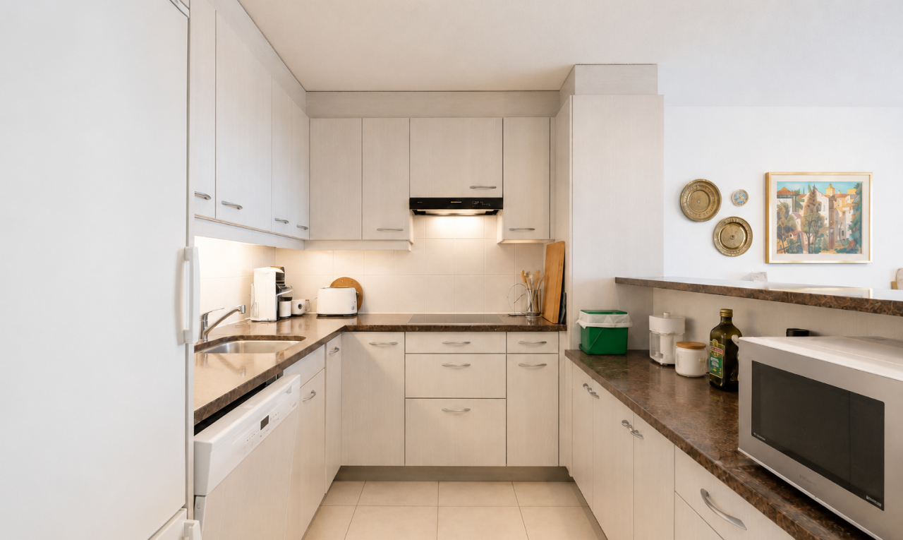 küche mit kühlschrank, mikrowelle, dark countertops, light floor, und inside property