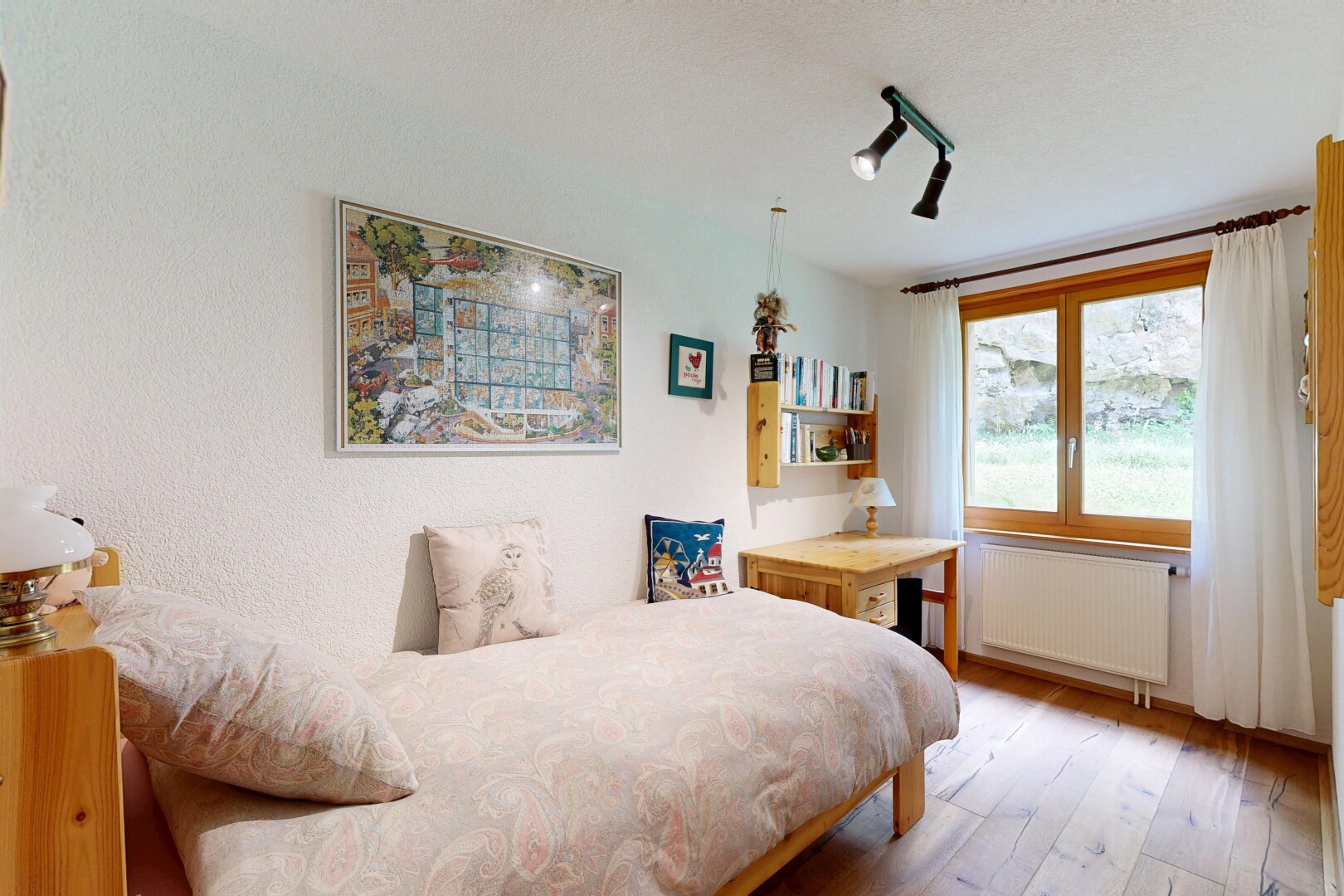 room / bedroom featuring radiator heating unit and light wood-style floors
