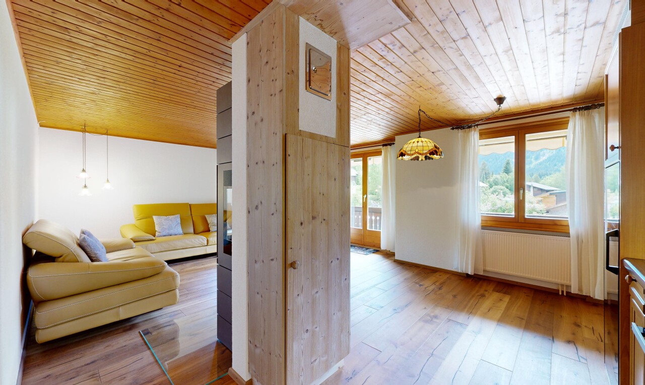 living area with wood ceiling, light wood-style floors, and radiator heating unit
