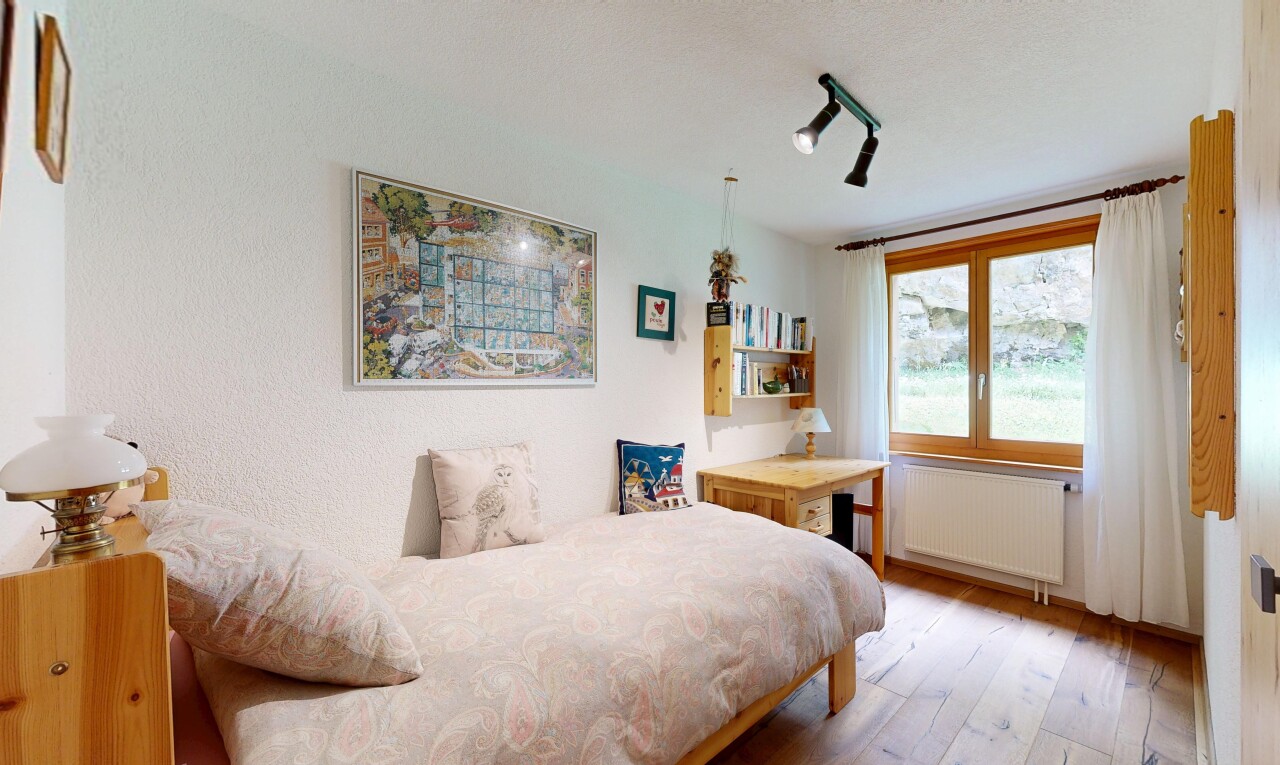 room / bedroom featuring radiator heating unit and light wood-style floors