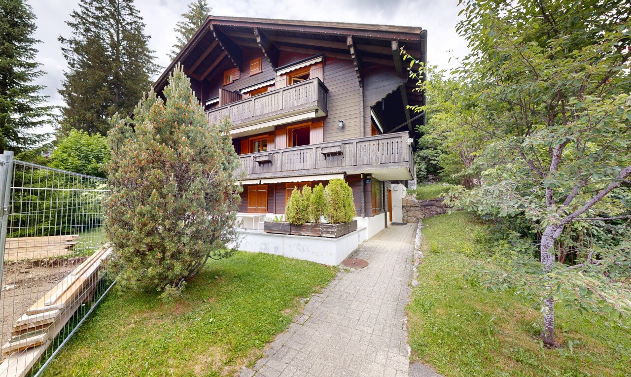 view of property featuring a balcony and a yard
