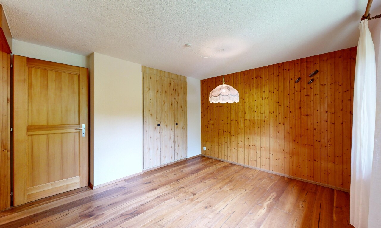 empty room with wooden walls and light wood finished floors