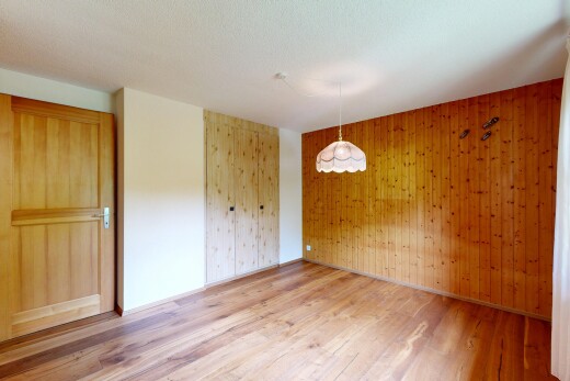 empty room with wooden walls and light wood finished floors