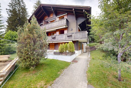 view of property featuring a balcony and a yard