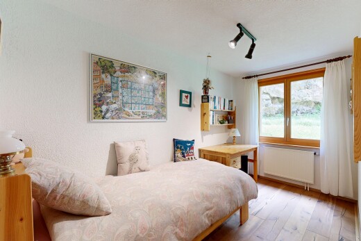 room / bedroom featuring radiator heating unit and light wood-style floors