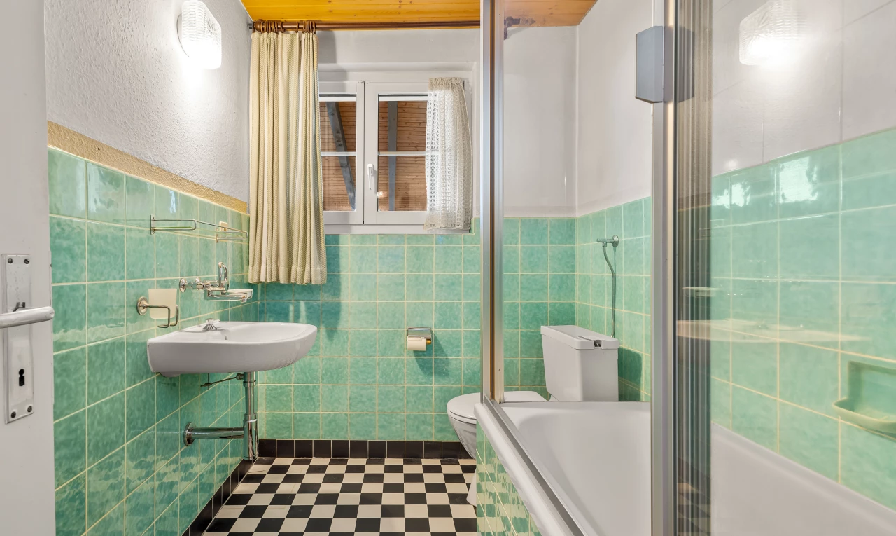 full bathroom featuring tile flooring, sink, toilet, tile walls, and shower / tub combination