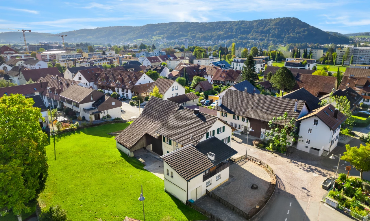 outdoor house featuring a mountain view and a lawn