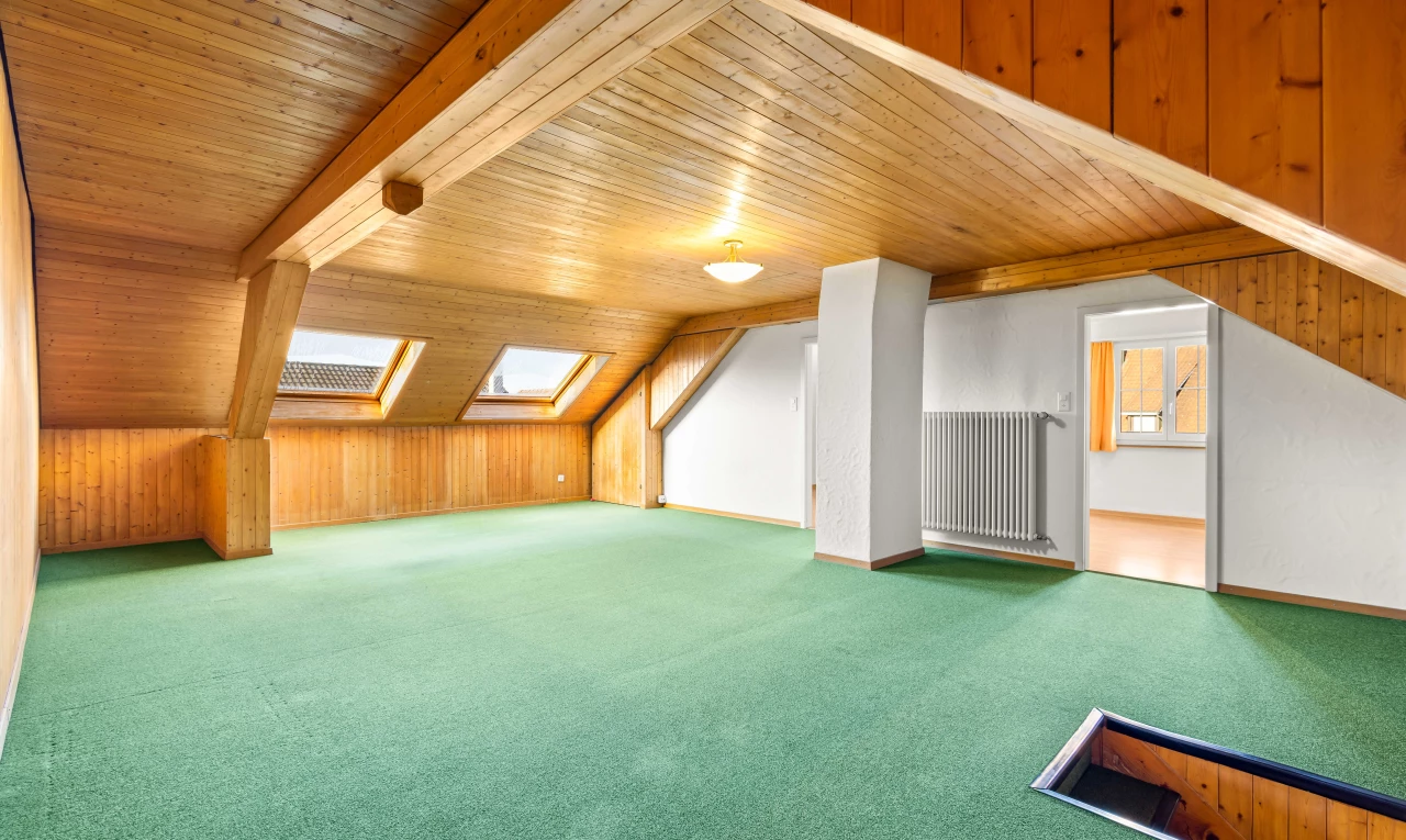 carpeted empty room with wooden walls, lofted ceiling with skylight, and wooden ceiling