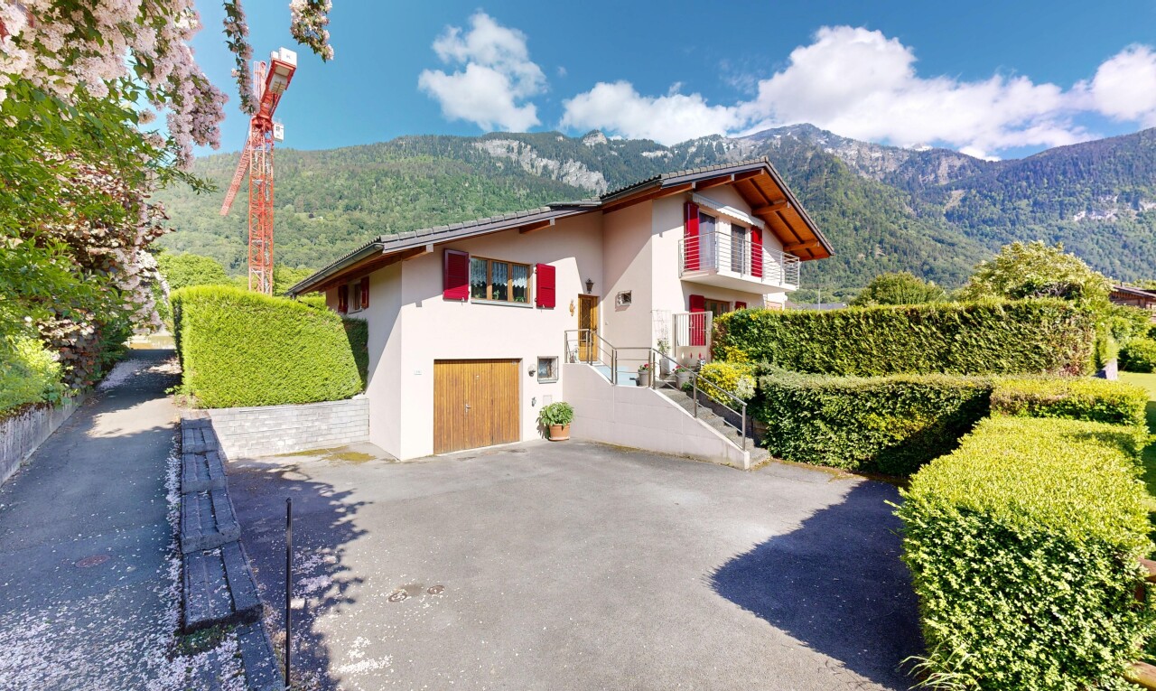 façade avec property visible, mountain view, day time, vue sur la montagne, et garage intégré