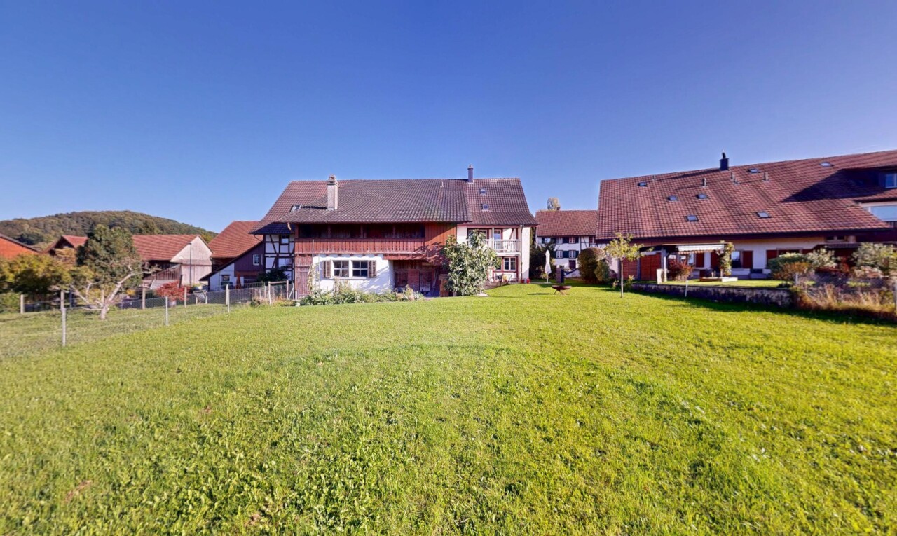 view of property featuring a lawn and a chimney