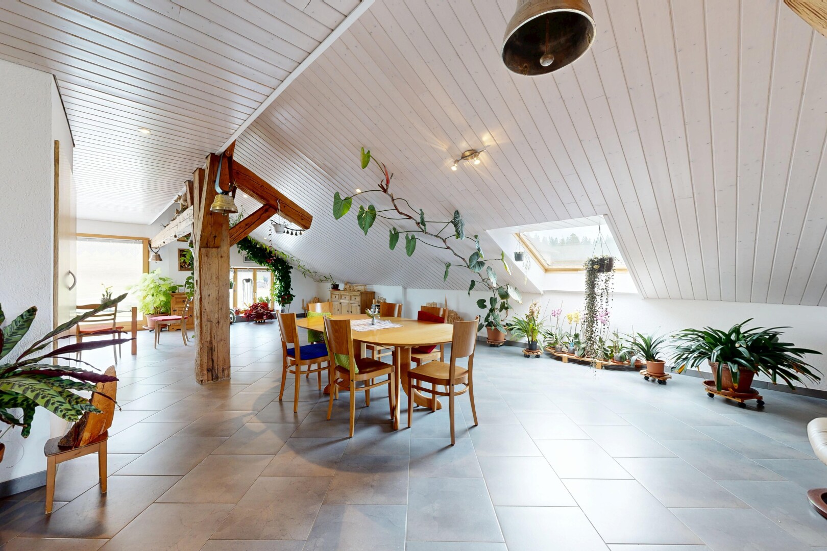dining room featuring a vaulted wooden ceiling and a skylight