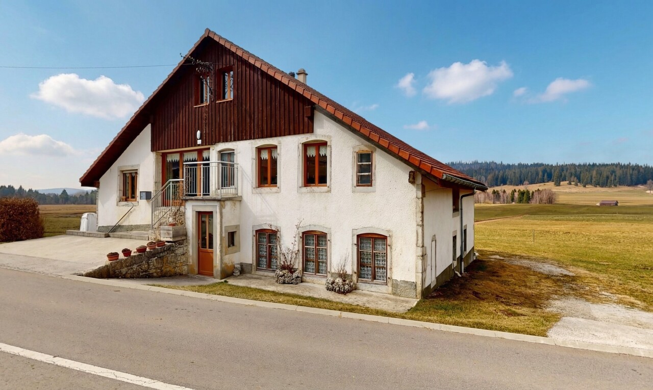 view of property with a balcony and stucco siding