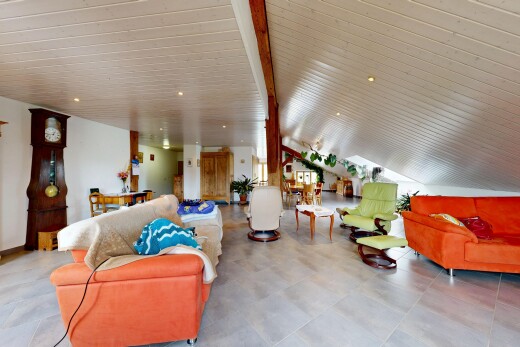 living area featuring recessed lighting and vaulted ceiling with beams