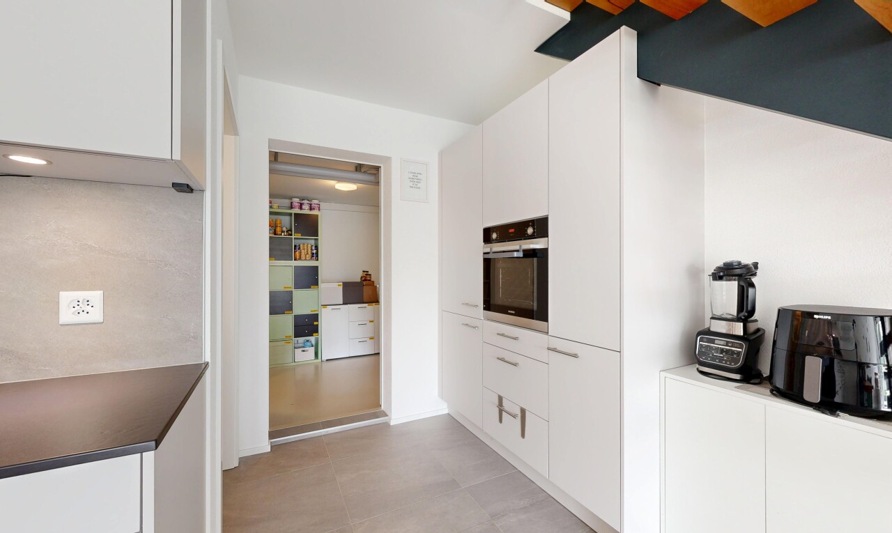 kitchen with oven and white cabinetry