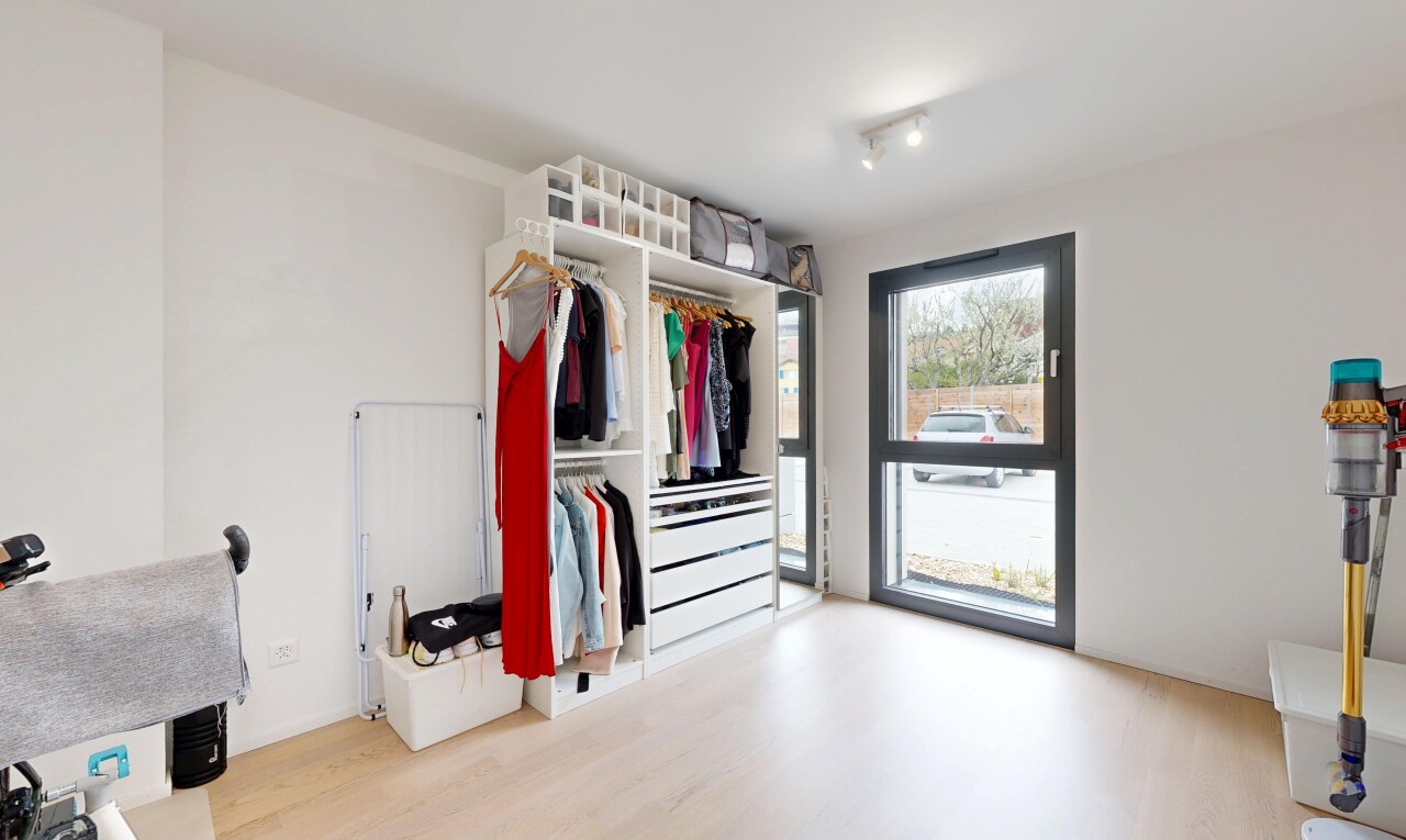 walk in closet with light wood-style floors