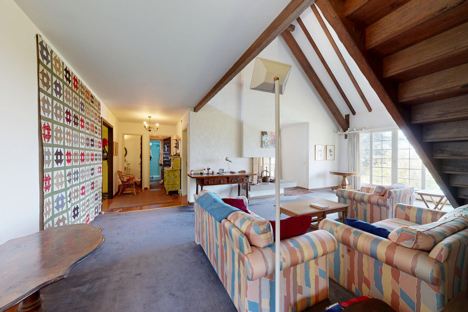 salon avec escaliers, high end ceiling, plafond voûté, vaulted ceiling, et inside property