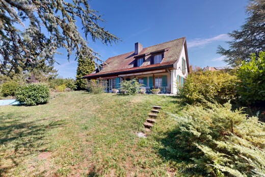 view of home featuring a yard and a chimney