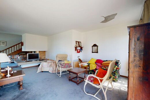living area featuring stairway and carpet floors
